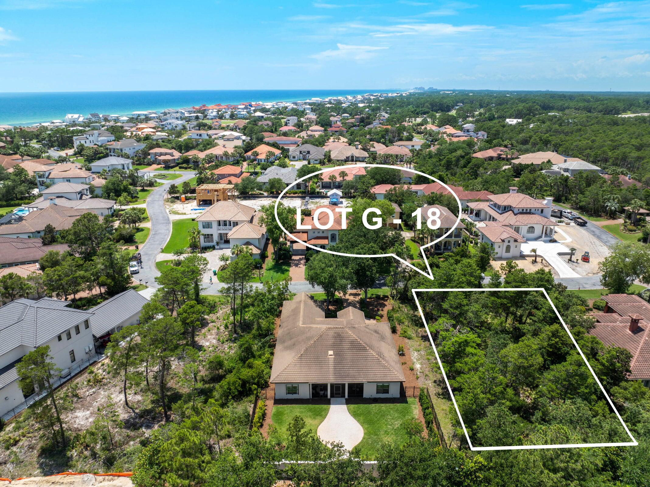 an aerial view of residential houses with outdoor space and street view