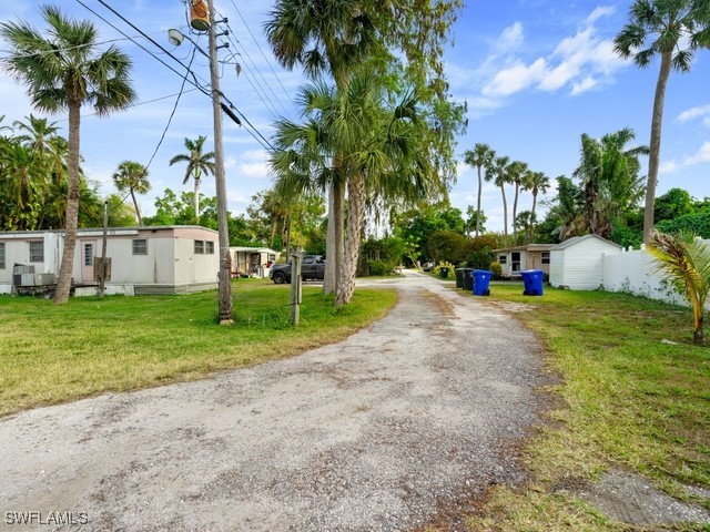 a view of backyard of house with green space