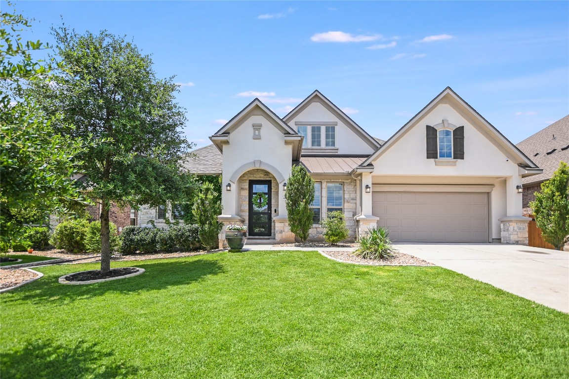 a front view of a house with a yard and garage