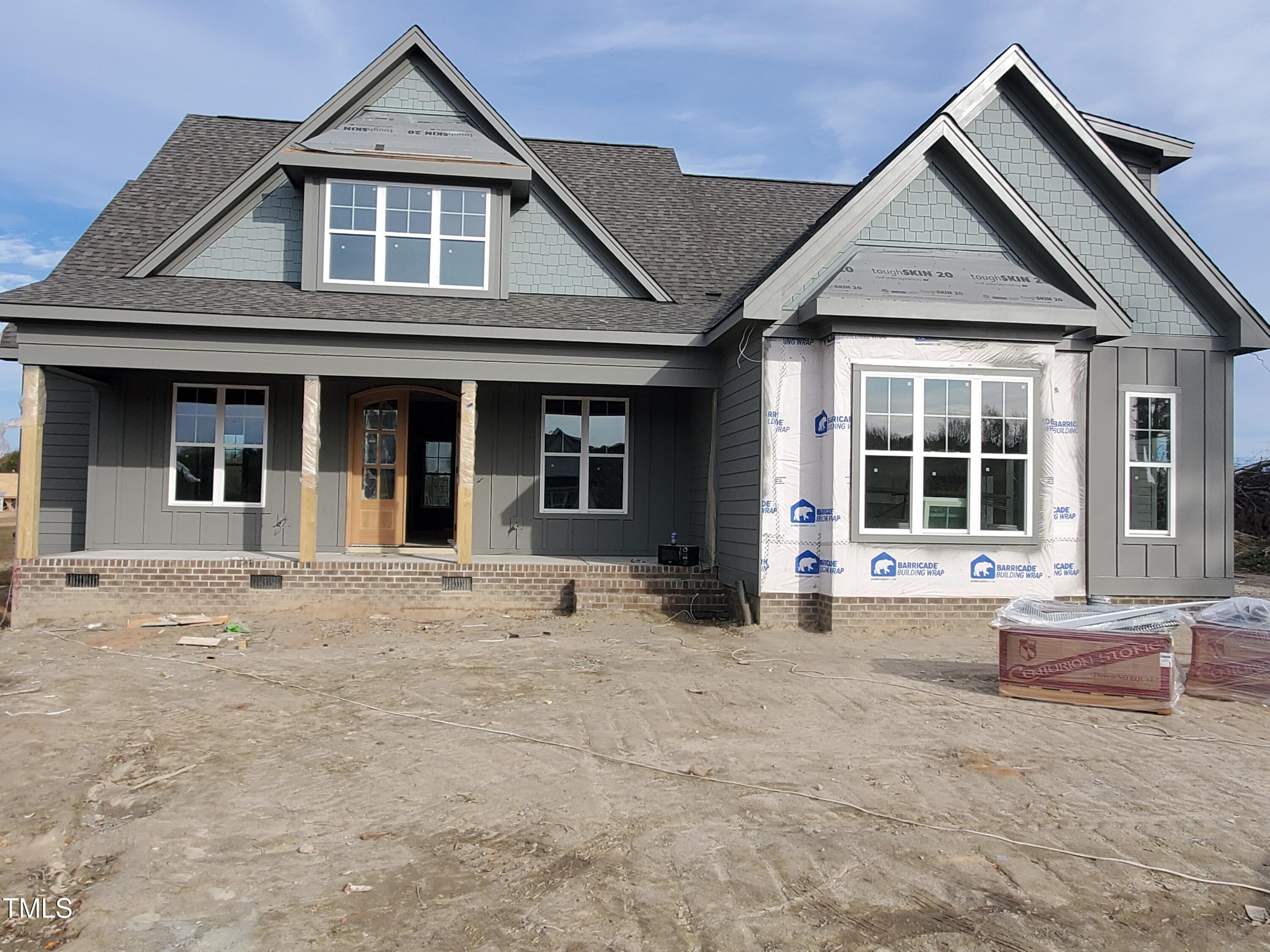 a front view of a house with a yard outdoor seating and garage