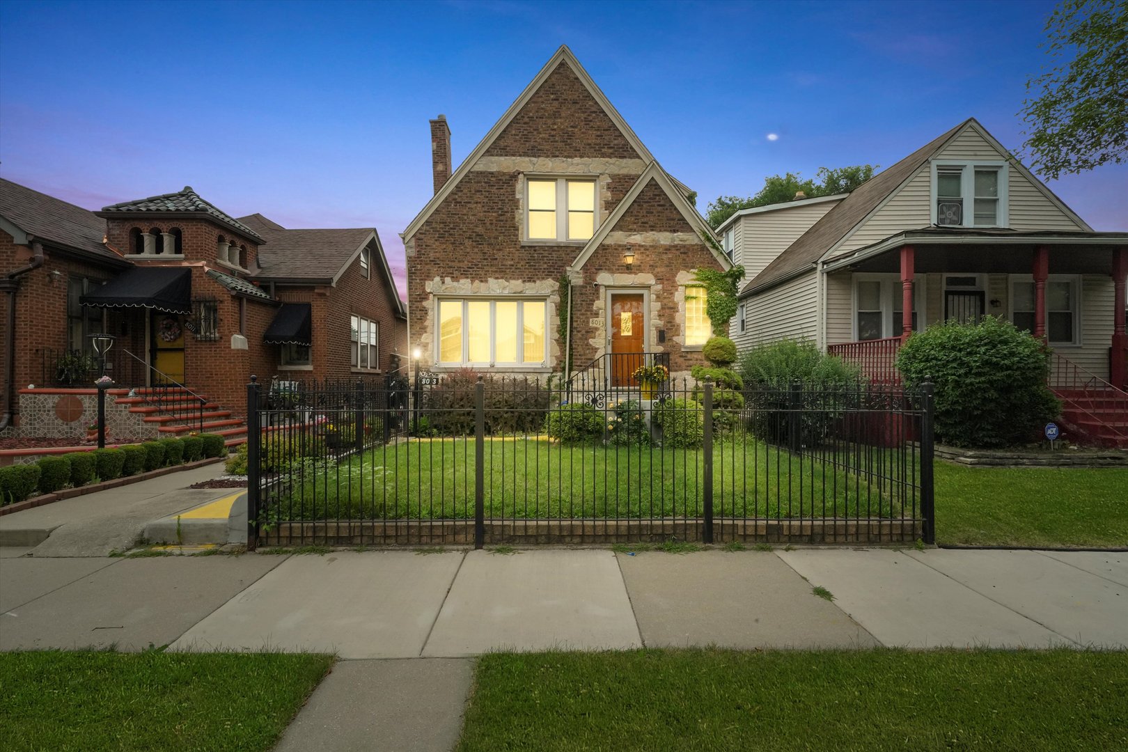 a front view of a house with a garden