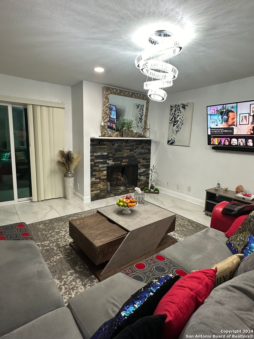 a living room with furniture and a chandelier