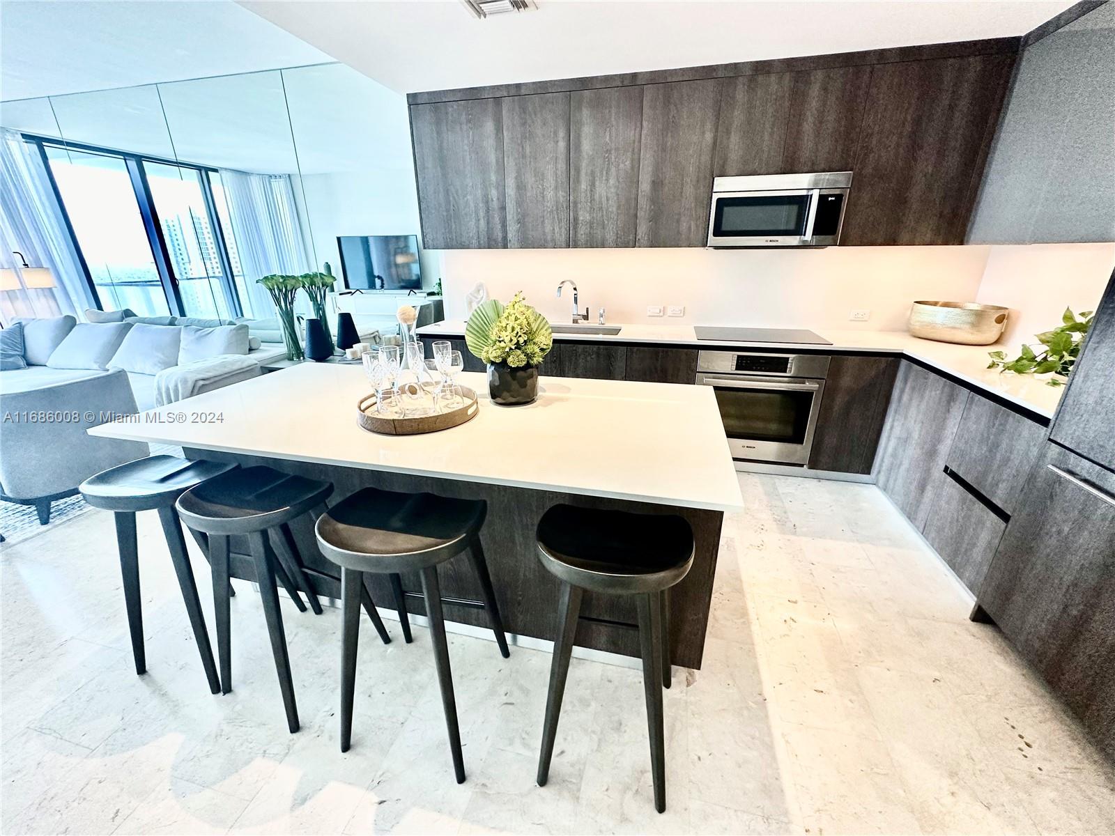 a kitchen with a table chairs and microwave