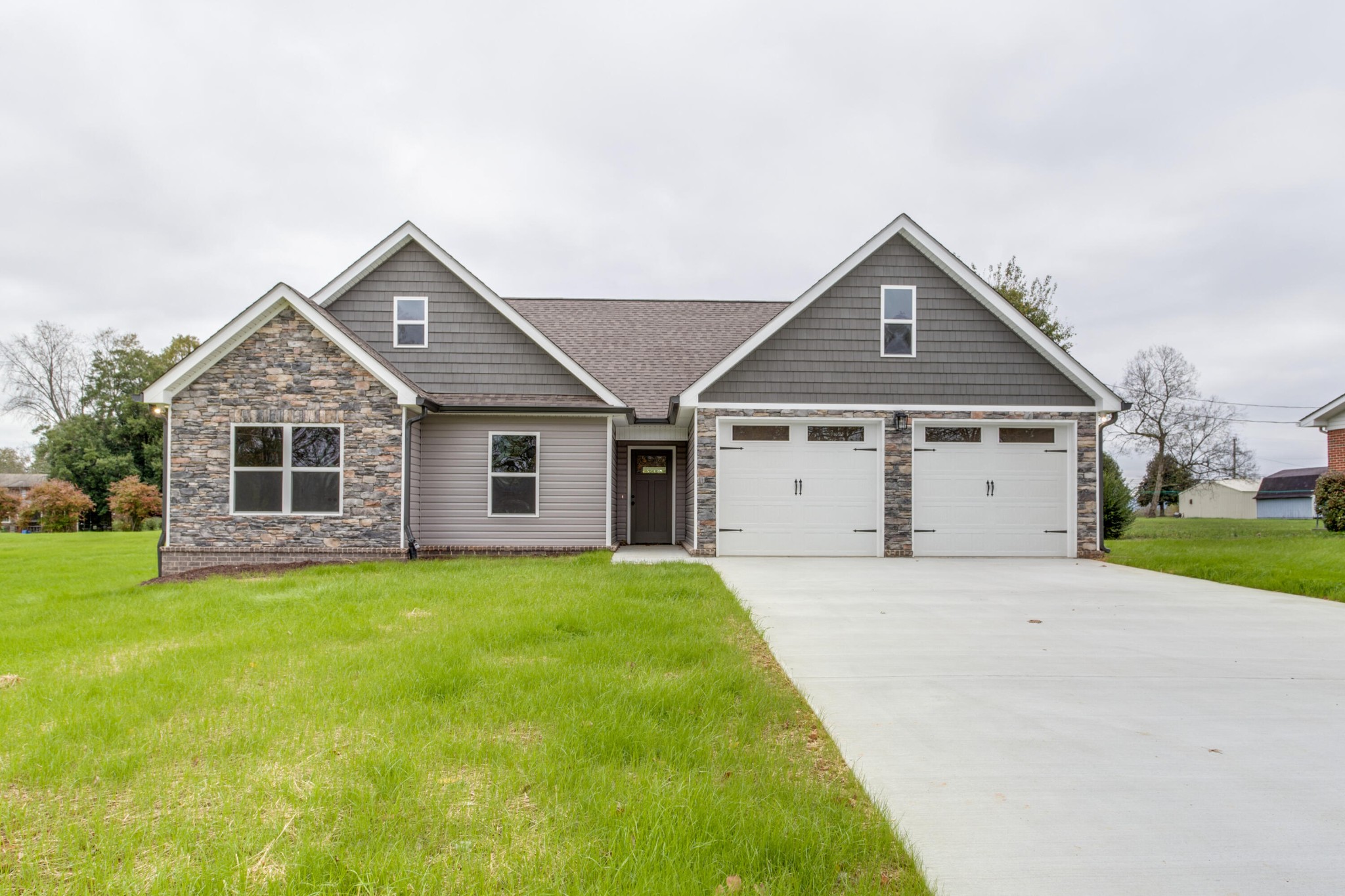 a front view of house with yard and green space