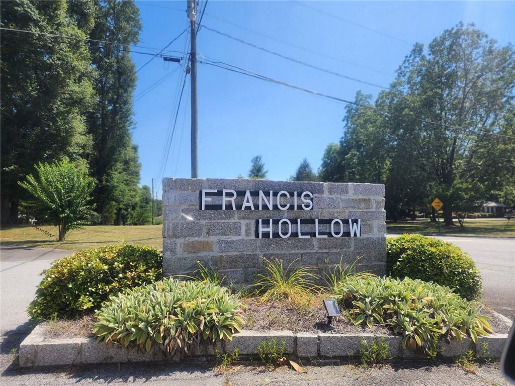 a sign broad in front of flowers