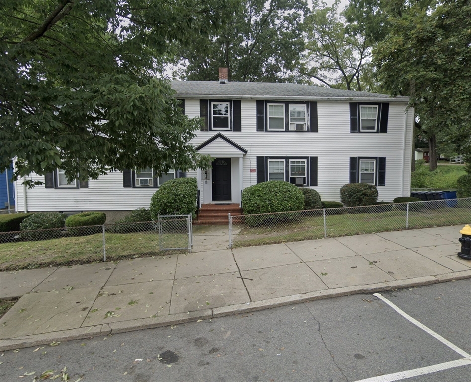 a front view of a house with a garden