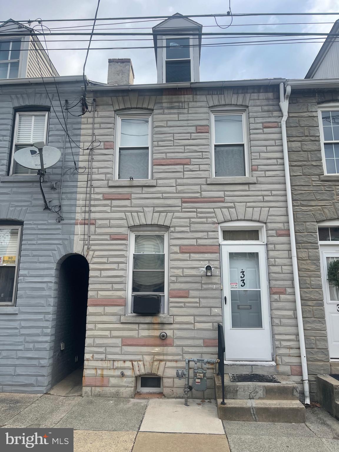 a brick house with a door and a yard