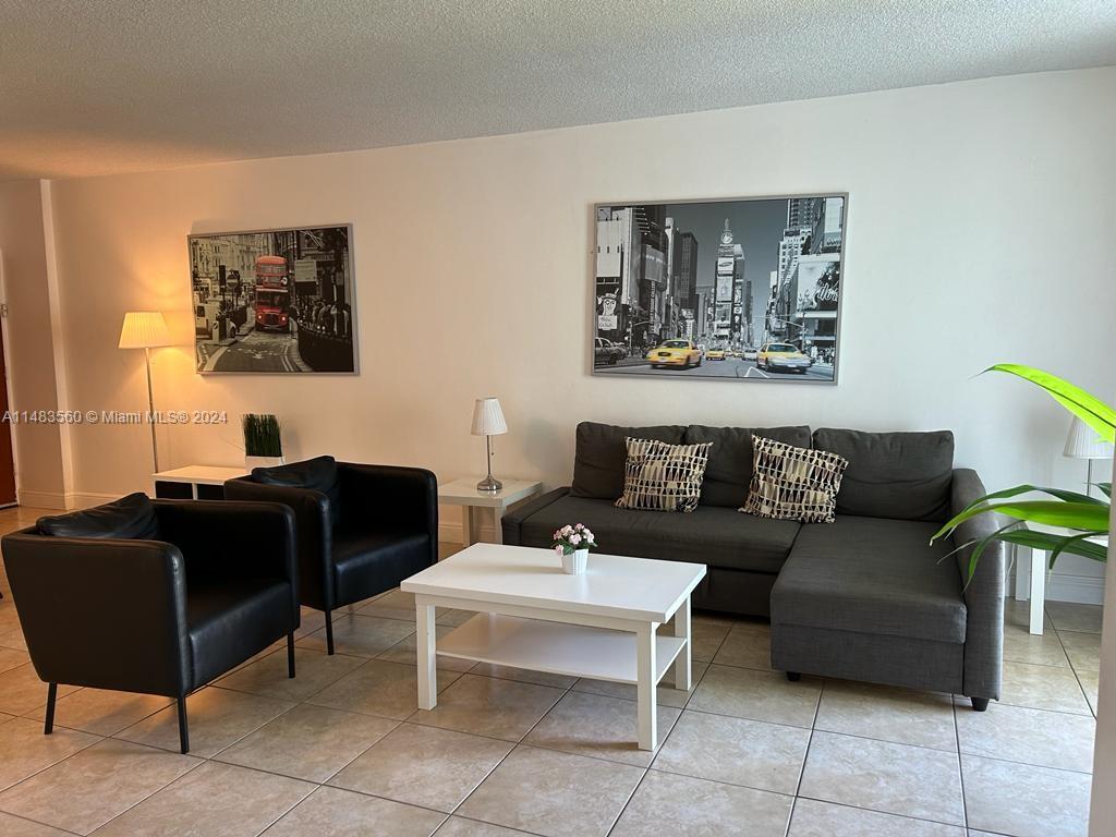 a living room with furniture and a lamp