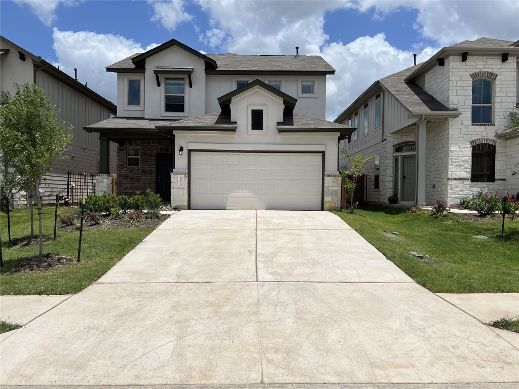 a front view of a house with yard