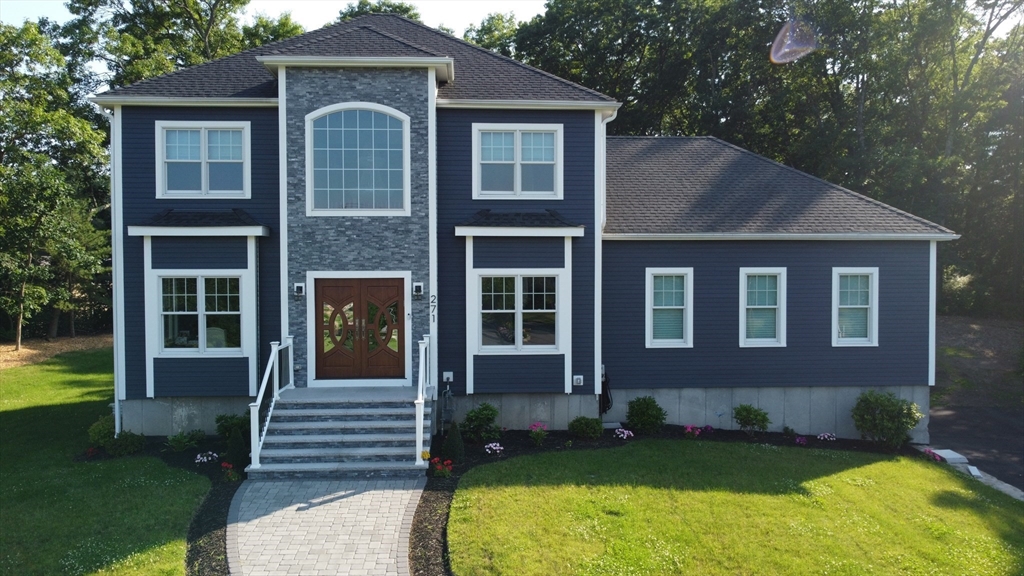 a front view of a house with garden