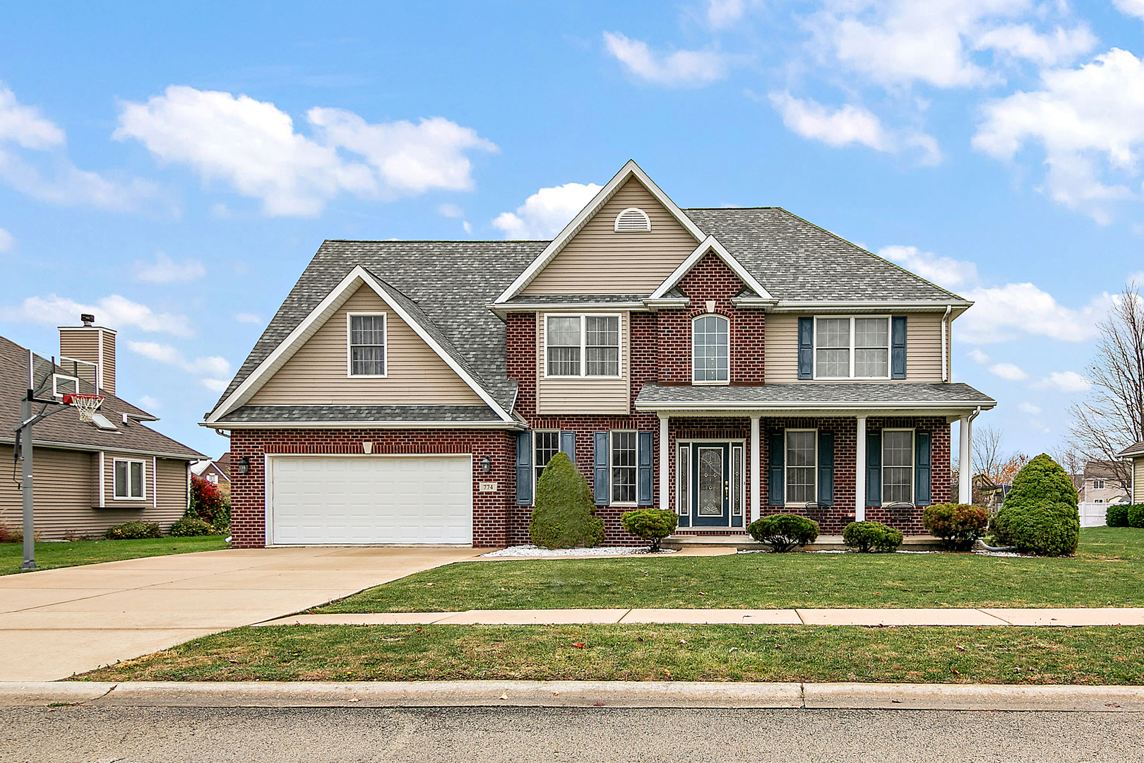 a front view of a house with a garden