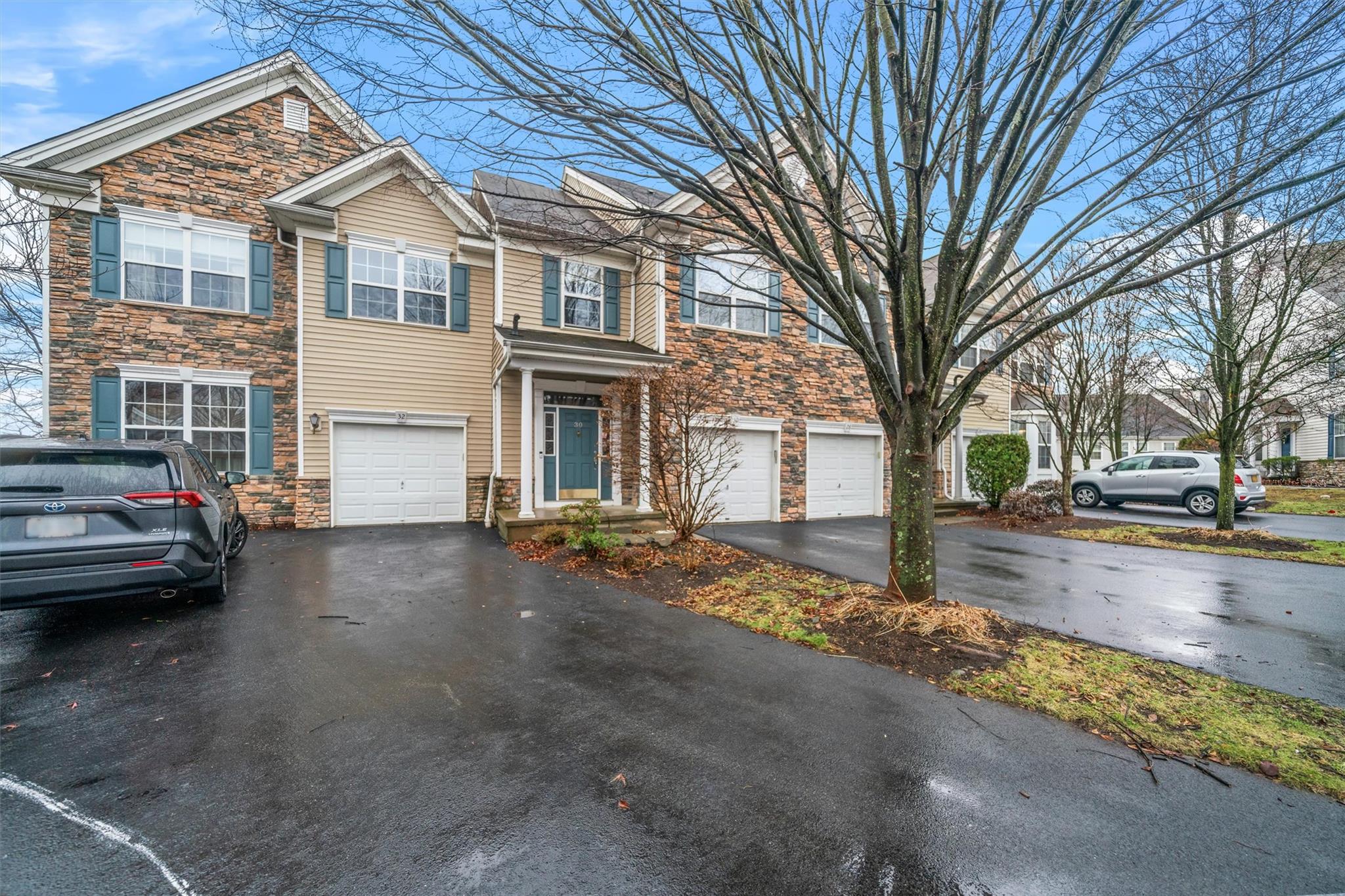 Townhome / multi-family property featuring a garage