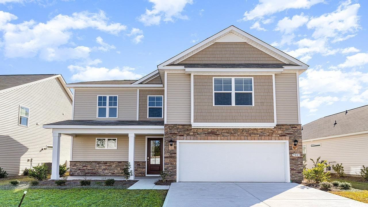 Craftsman-style home featuring a front yard and a