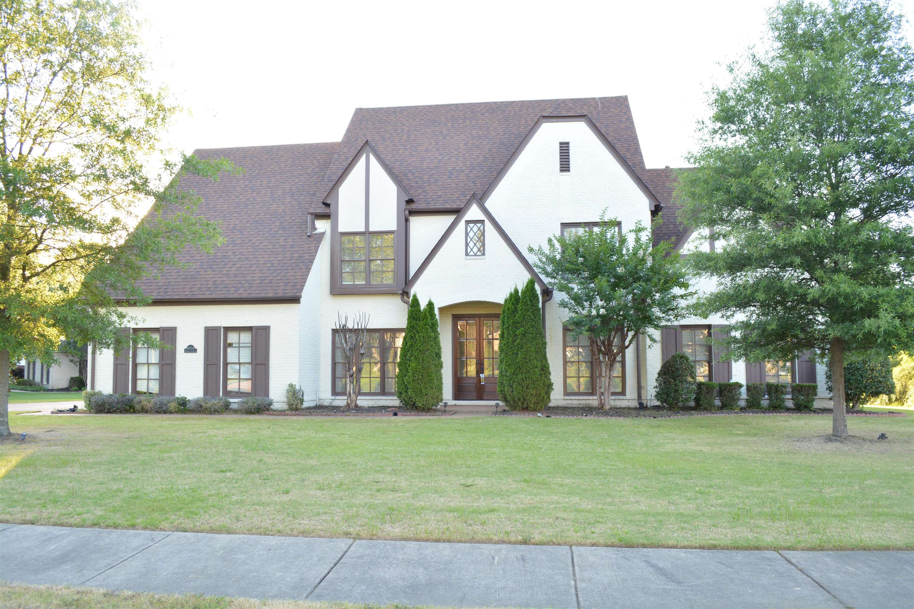 Tudor-style house featuring a front lawn