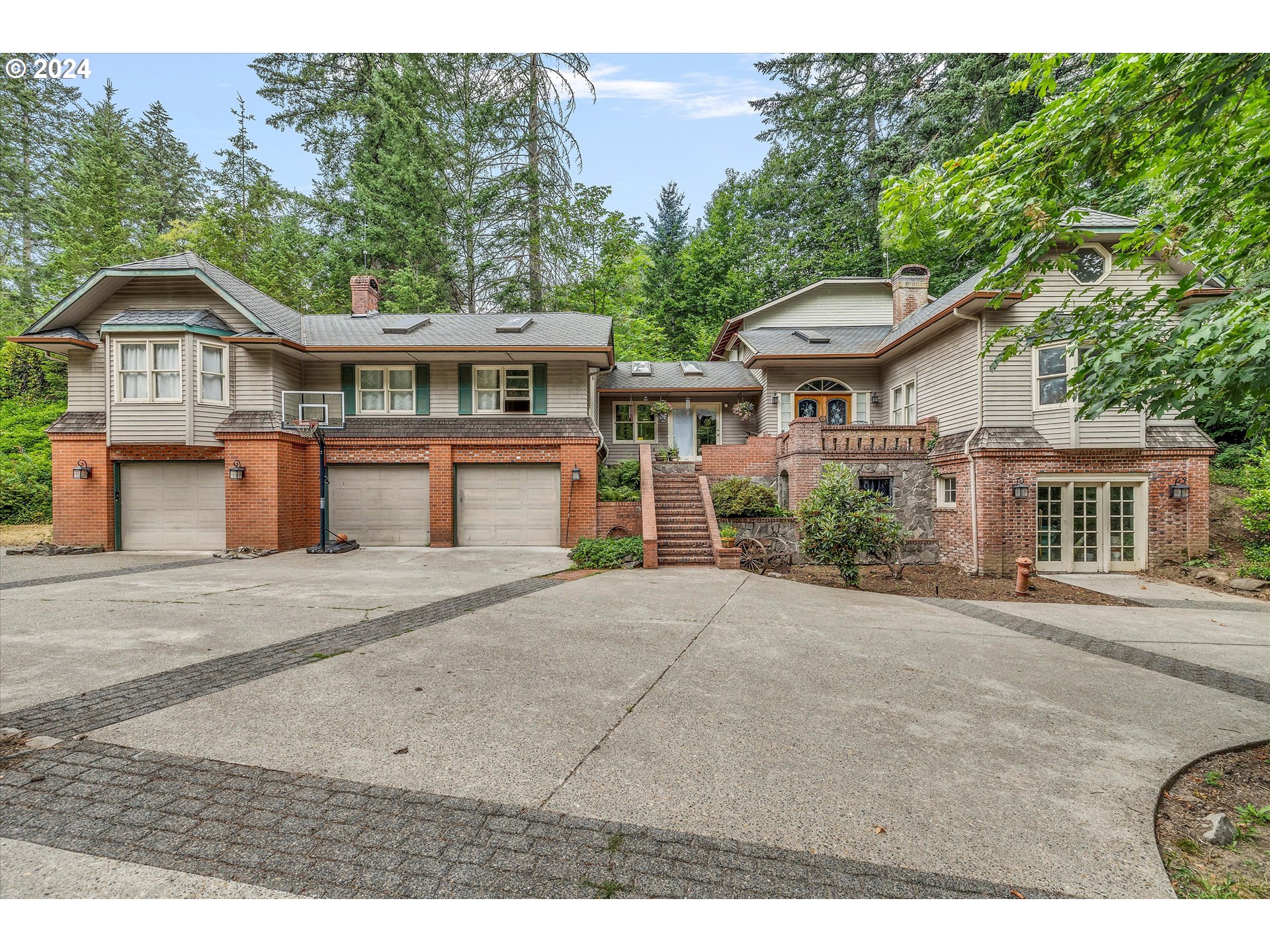 a front view of a house with a garden and trees