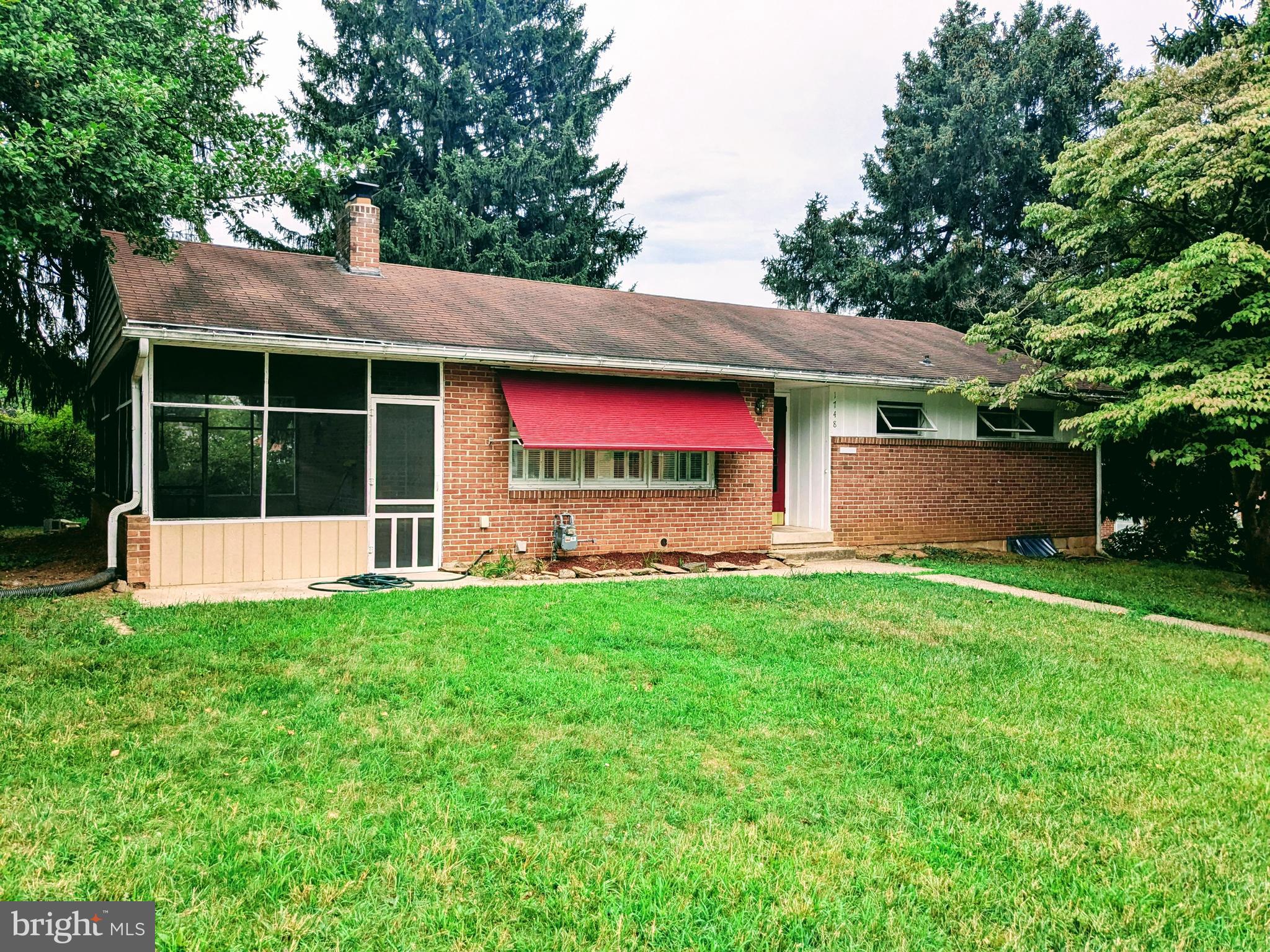 a view of house with backyard and deck