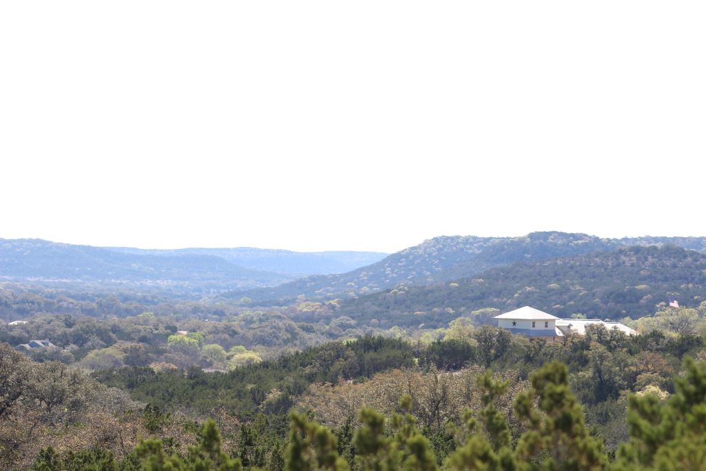 a view of a mountain in the distance in a field