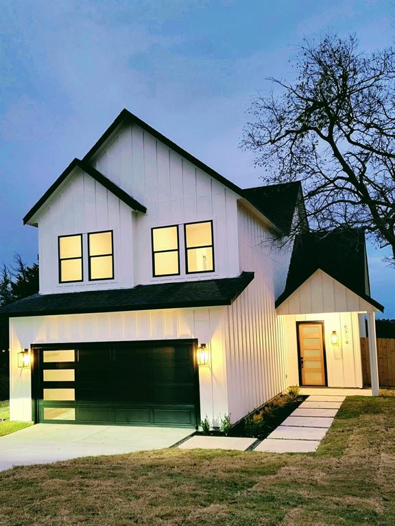 a front view of a house with a yard garage and window