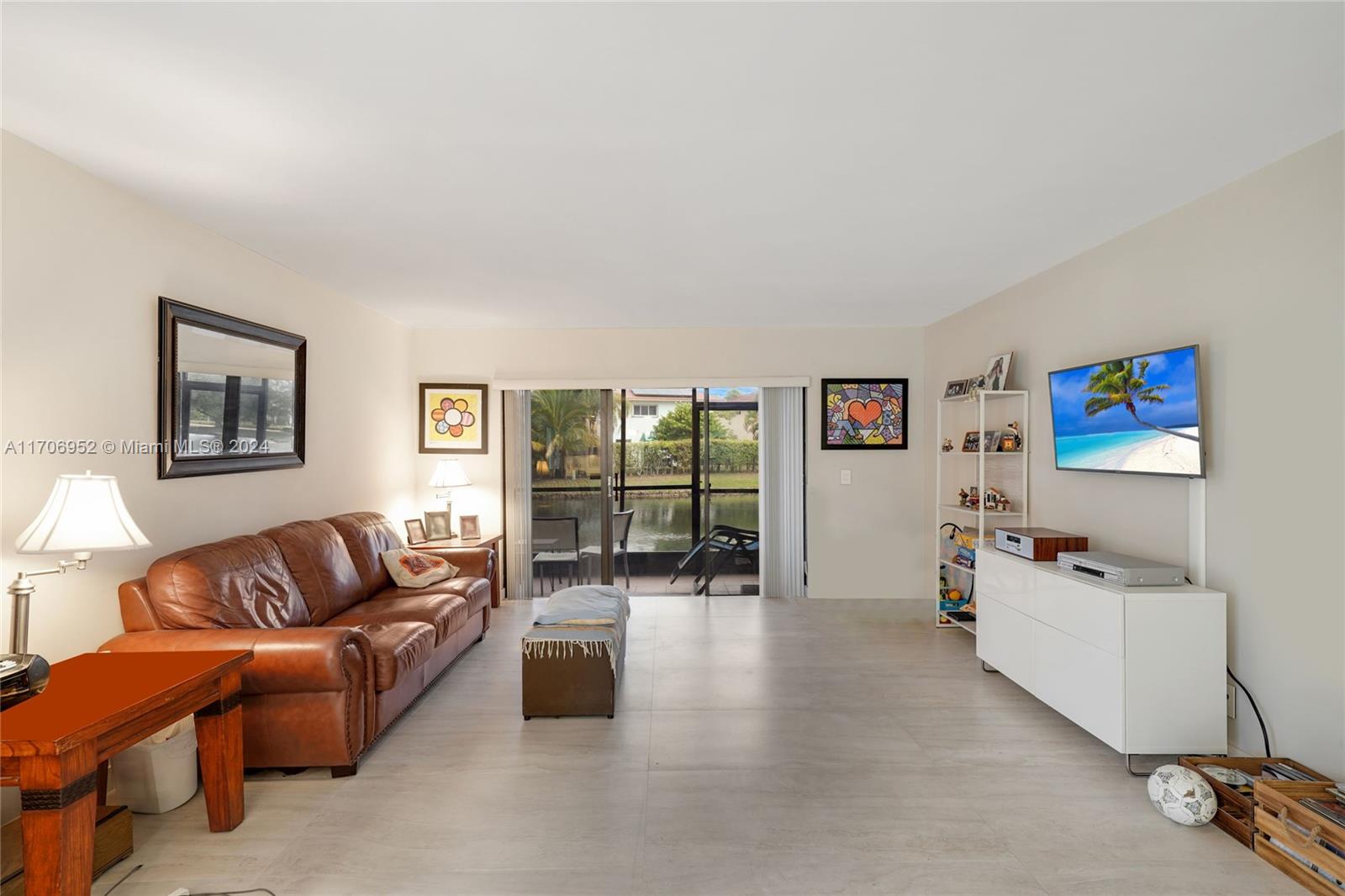 a living room with furniture large window and flat screen tv