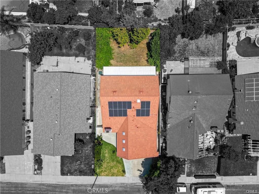 an aerial view of a house with a yard and a fountain