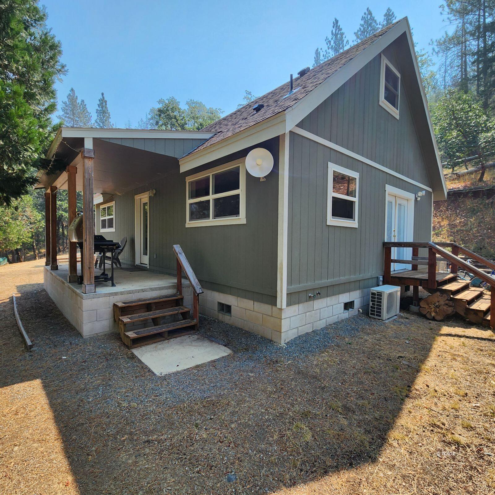 a view of a house with backyard porch and sitting area