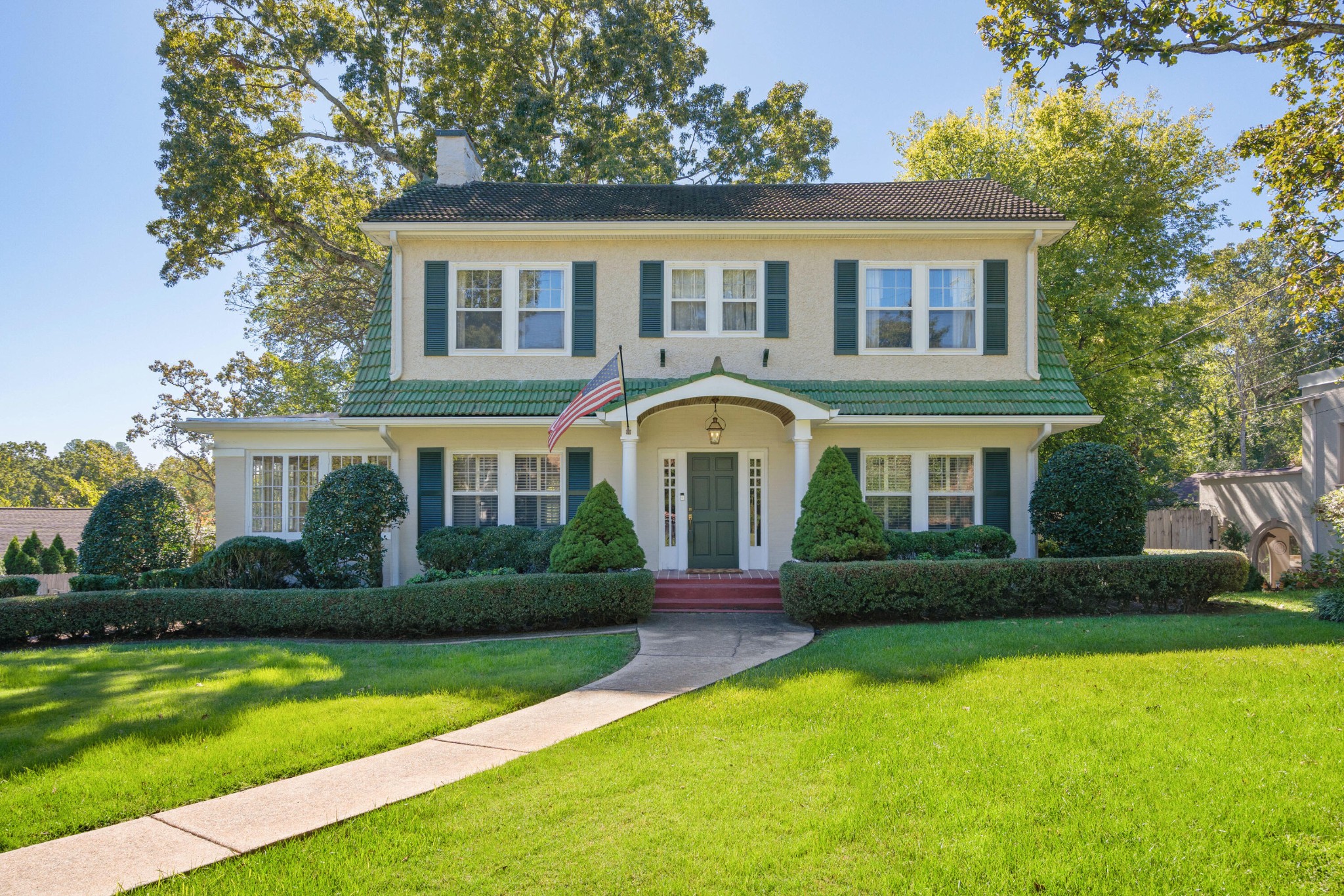 a front view of a house with garden