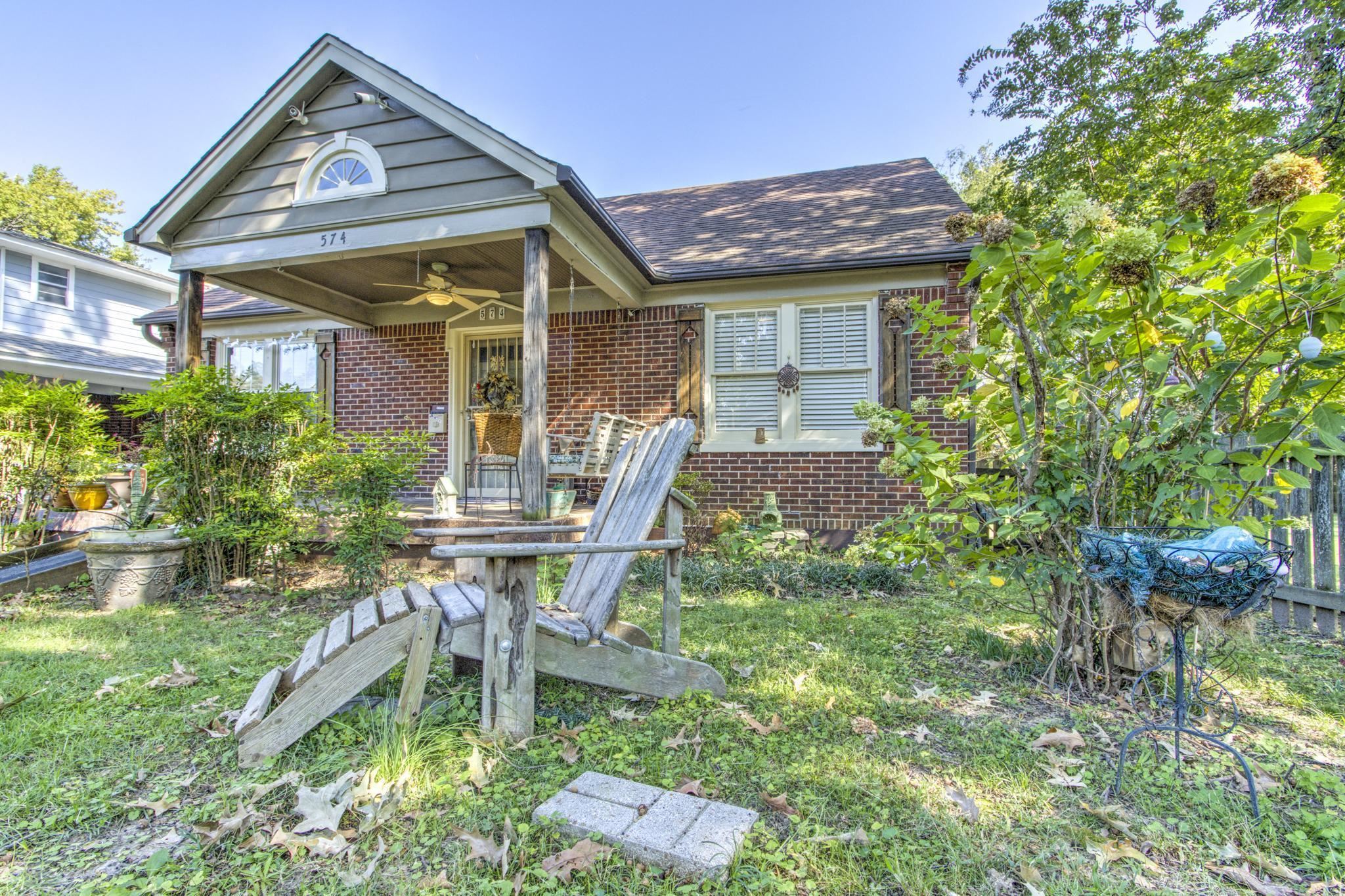 Exterior space with a front lawn and ceiling fan