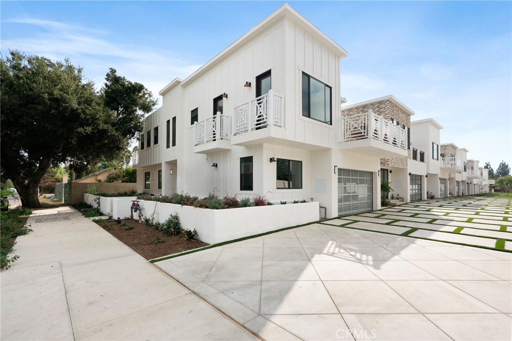 a view of a white house with a outdoor space