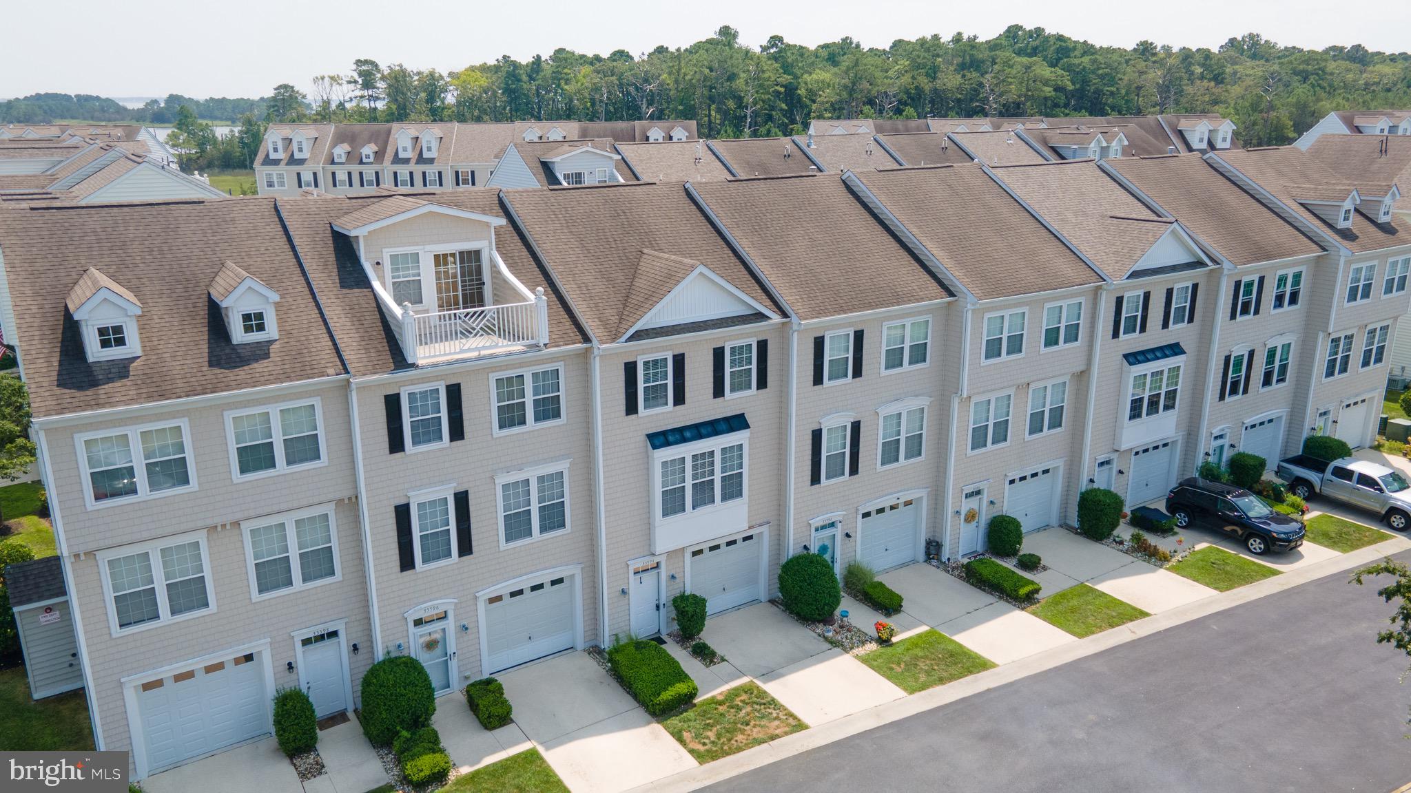 a aerial view of a brick building next to a yard