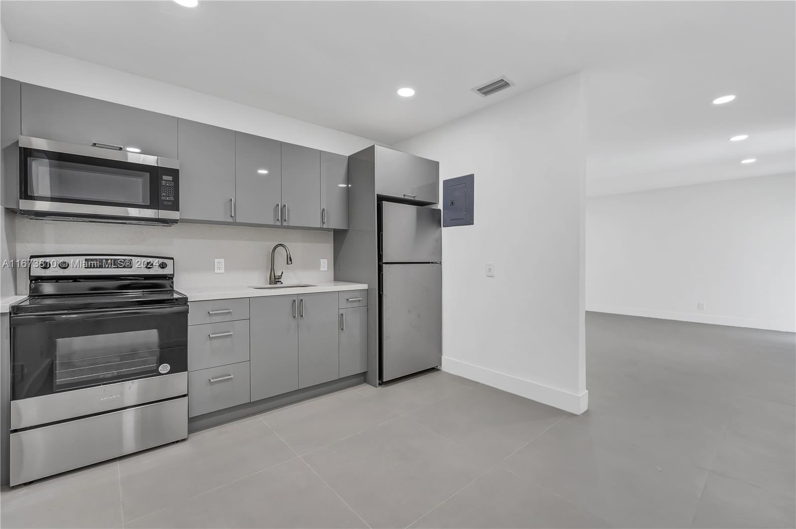 a kitchen with a sink and stainless steel appliances