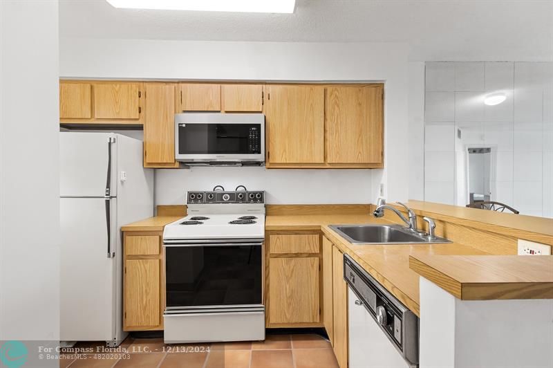 a kitchen with a sink stove and microwave