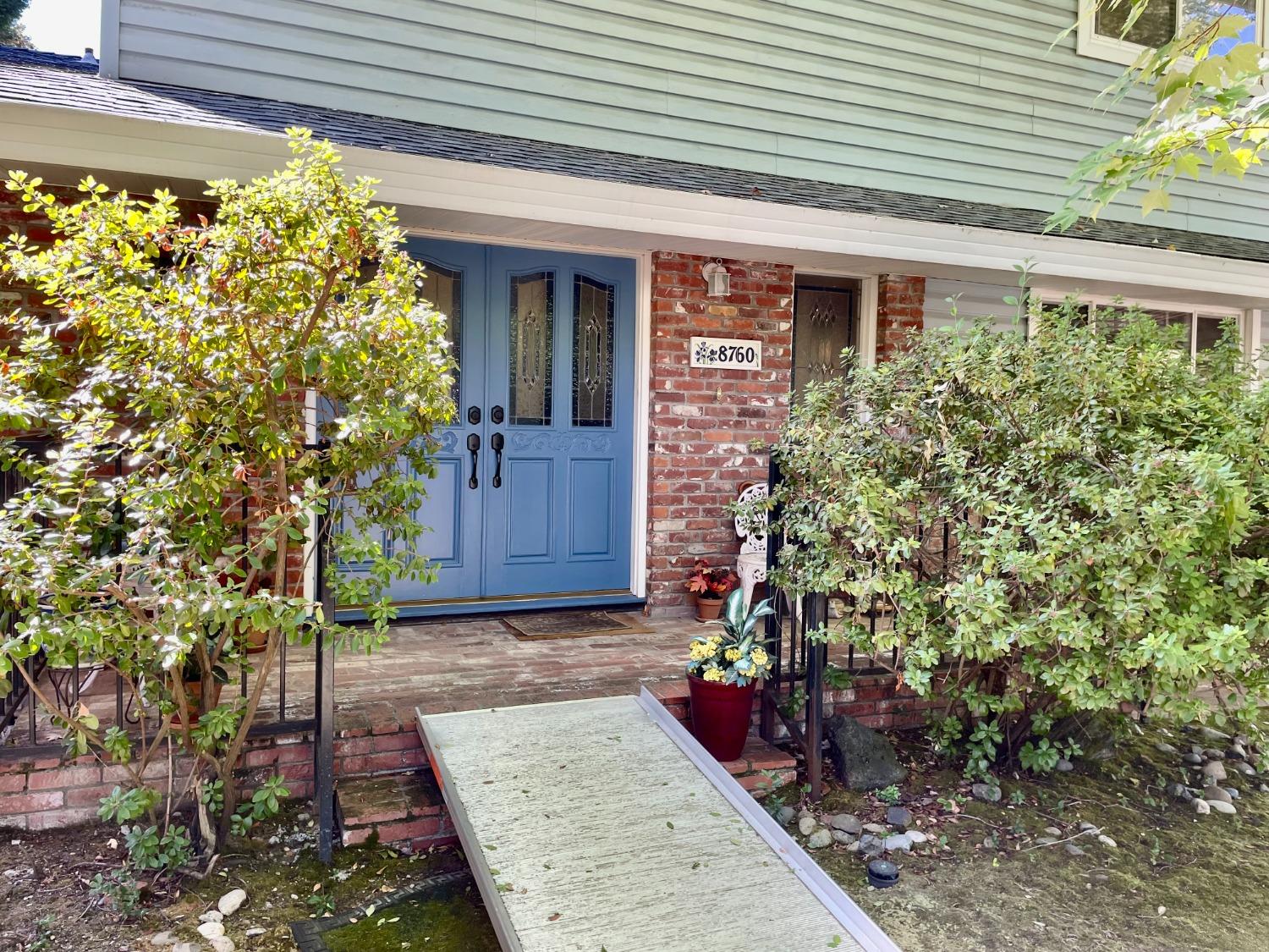 a view of a house with potted plants