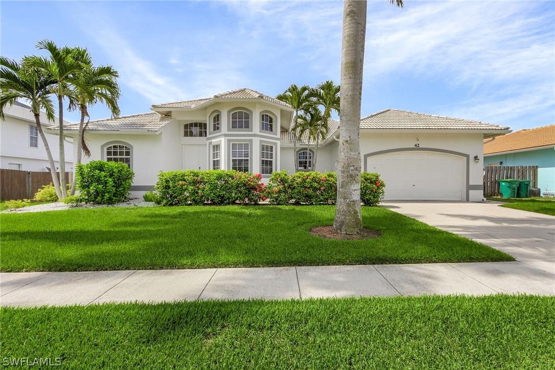 a front view of a house with a garden