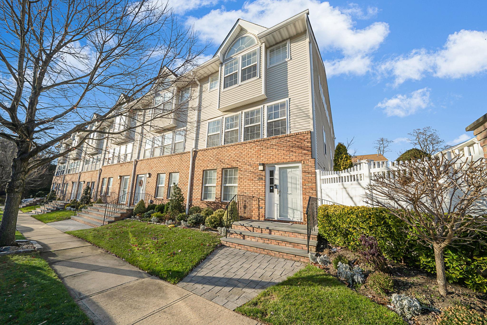 a front view of a residential apartment building with a yard