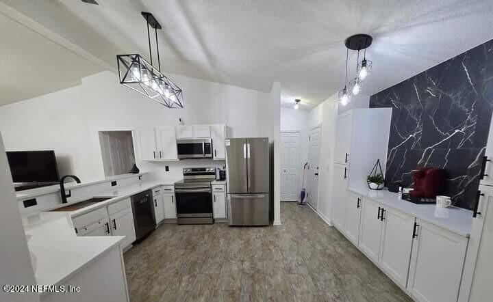 a kitchen with stainless steel appliances a refrigerator sink and microwave