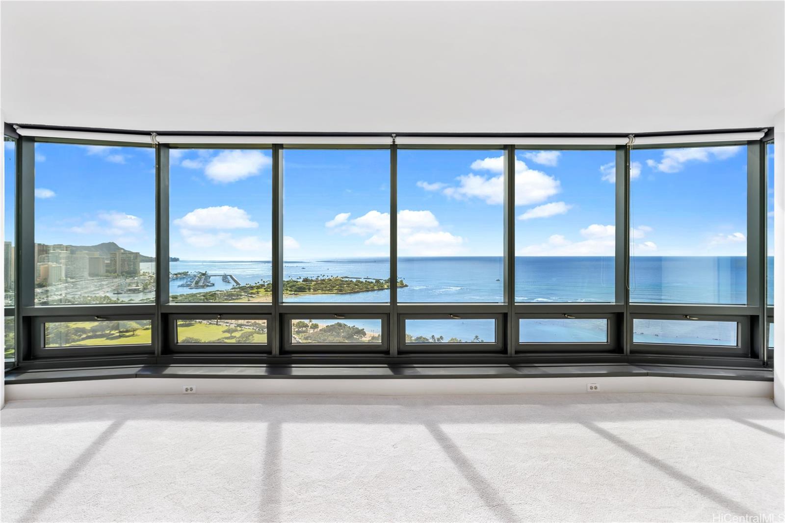 an empty room with sliding glass door and the side of a road