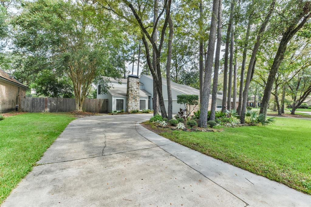 Widened driveway, beautiful trees an landscaping along with stone chimney will take your breath away.