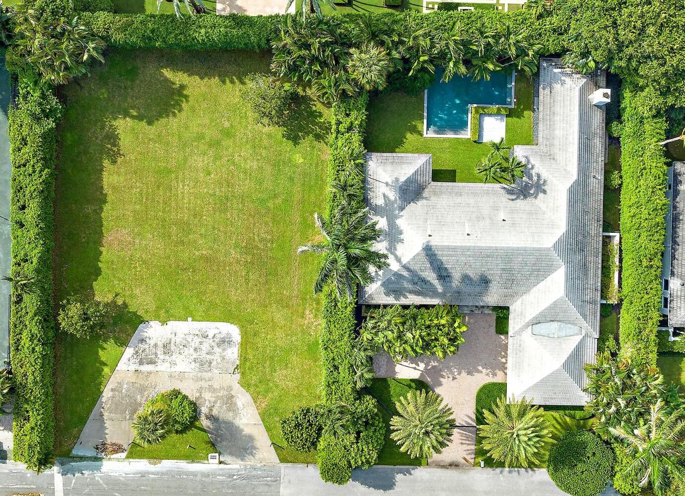 an aerial view of a house with a yard basket ball court and outdoor seating