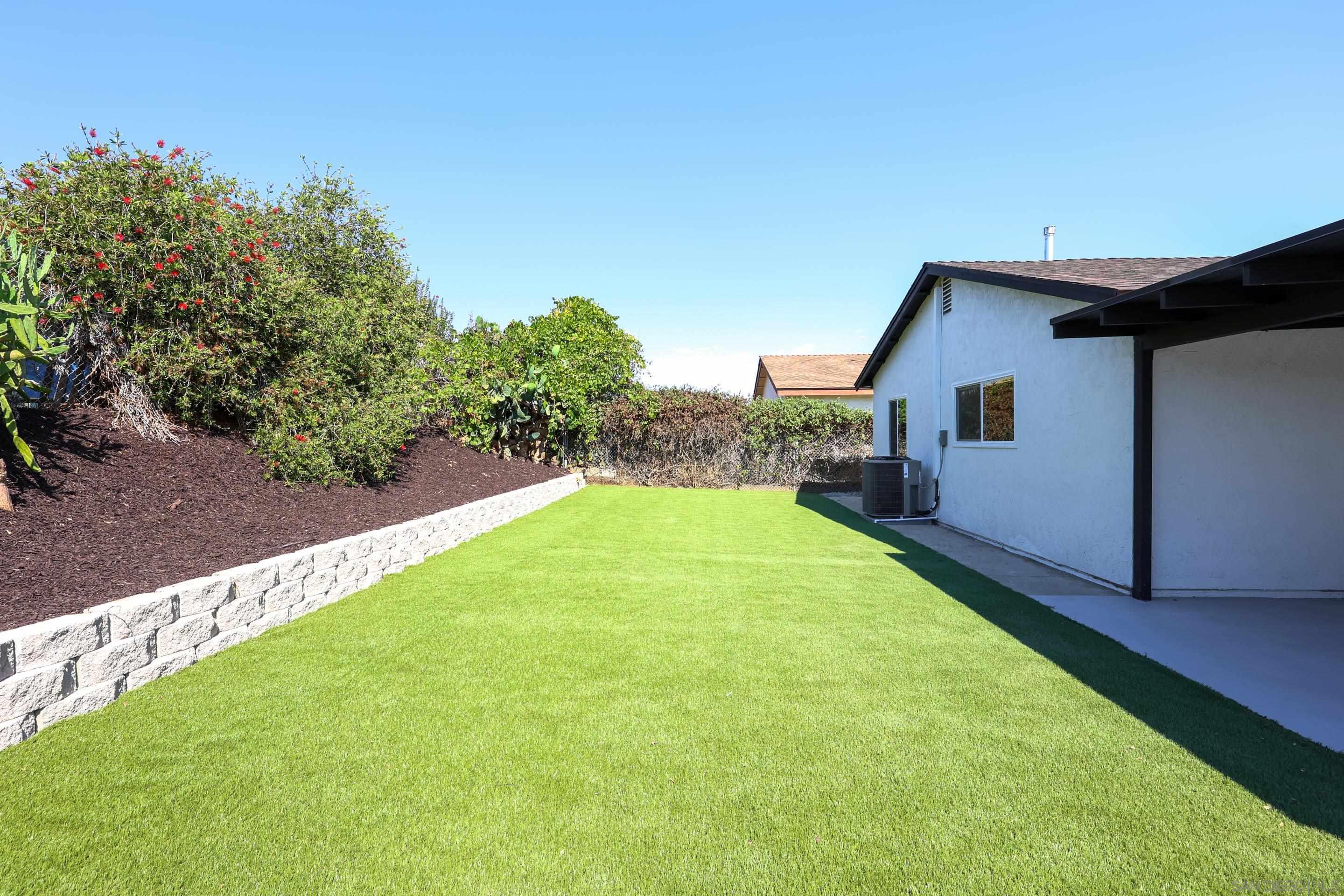 a view of backyard with a garden and plants