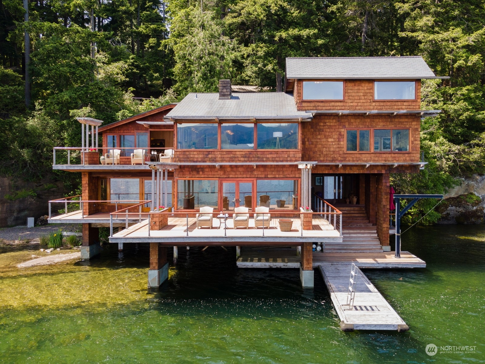 a aerial view of a house with swimming pool and sitting area