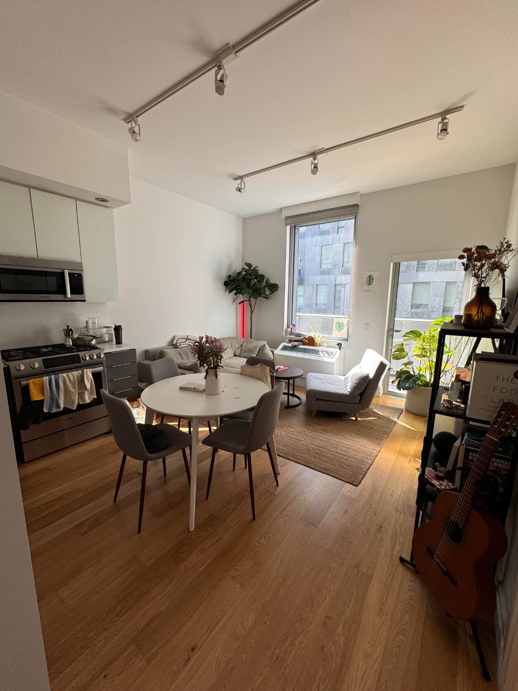 a living room with furniture and a wooden floor