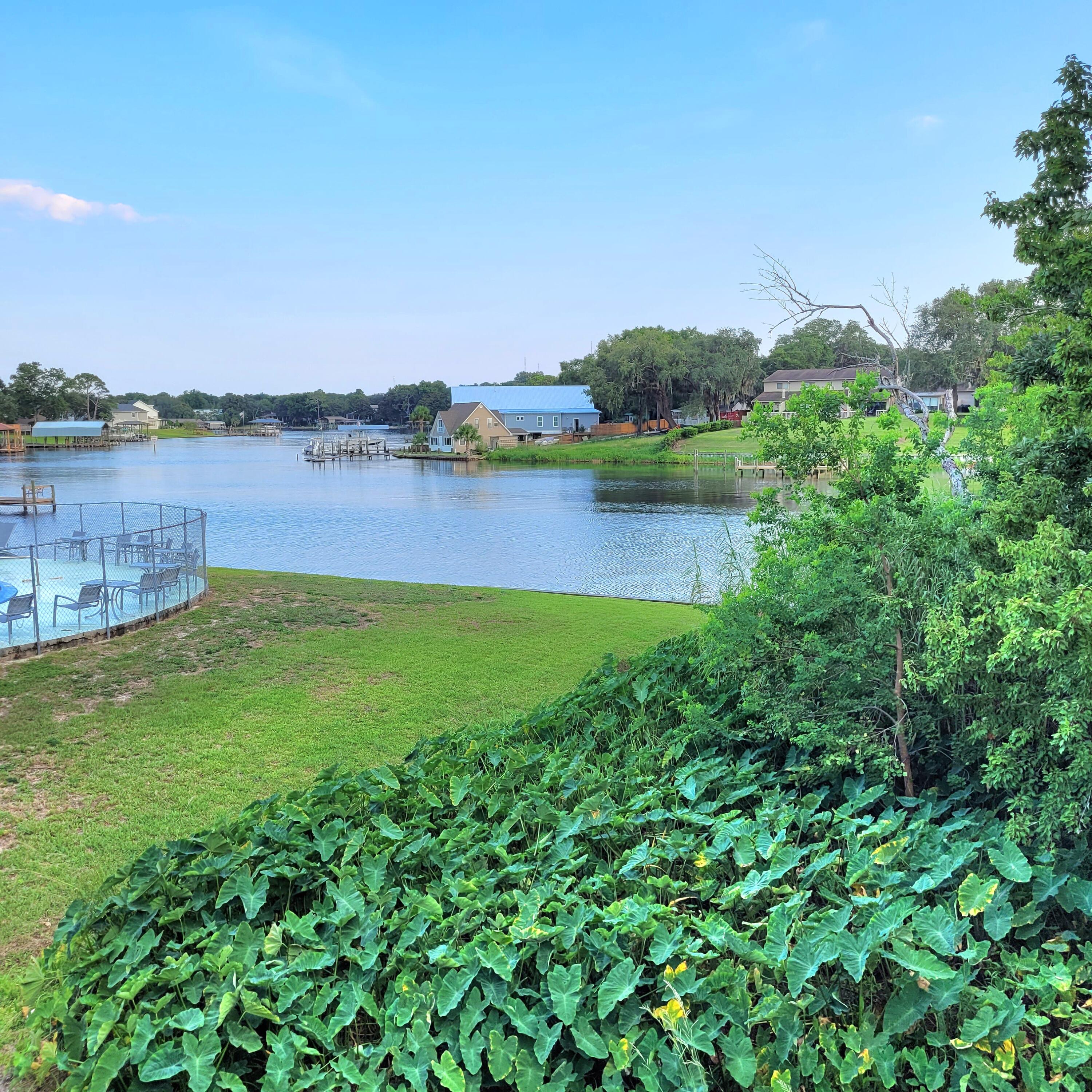 a view of a lake with houses in the back