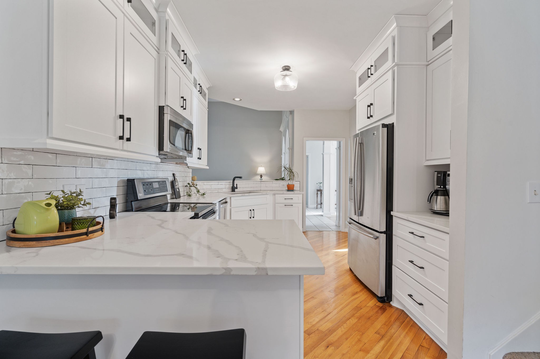 This contemporary kitchen has all of the elements of timeless accents. With a coffee bar area to the right of the fridge, all SS appliances, quartz counters, a classic bricklay backsplash, & brand new cabinets. This space is ready for the home Chef!