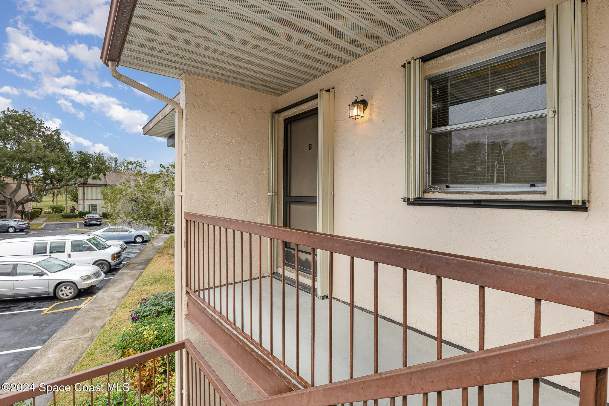 a view of a porch with furniture and floor to ceiling window