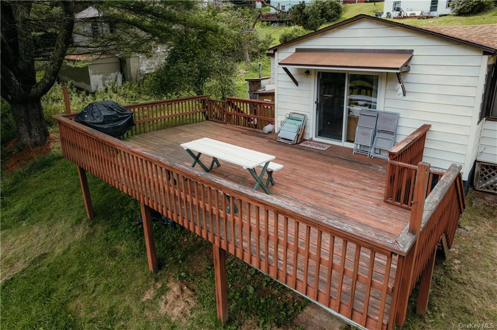 a view of a roof deck with chair and wooden floor