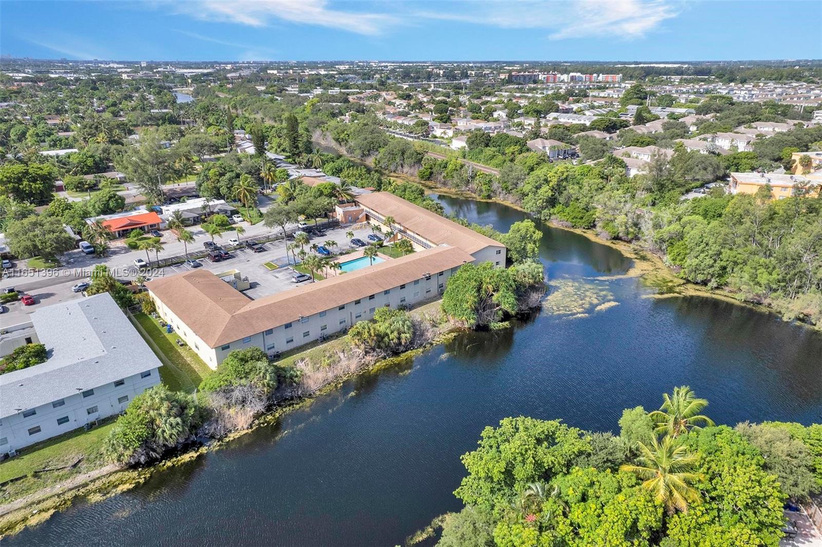 an aerial view of a house with a garden and lake view