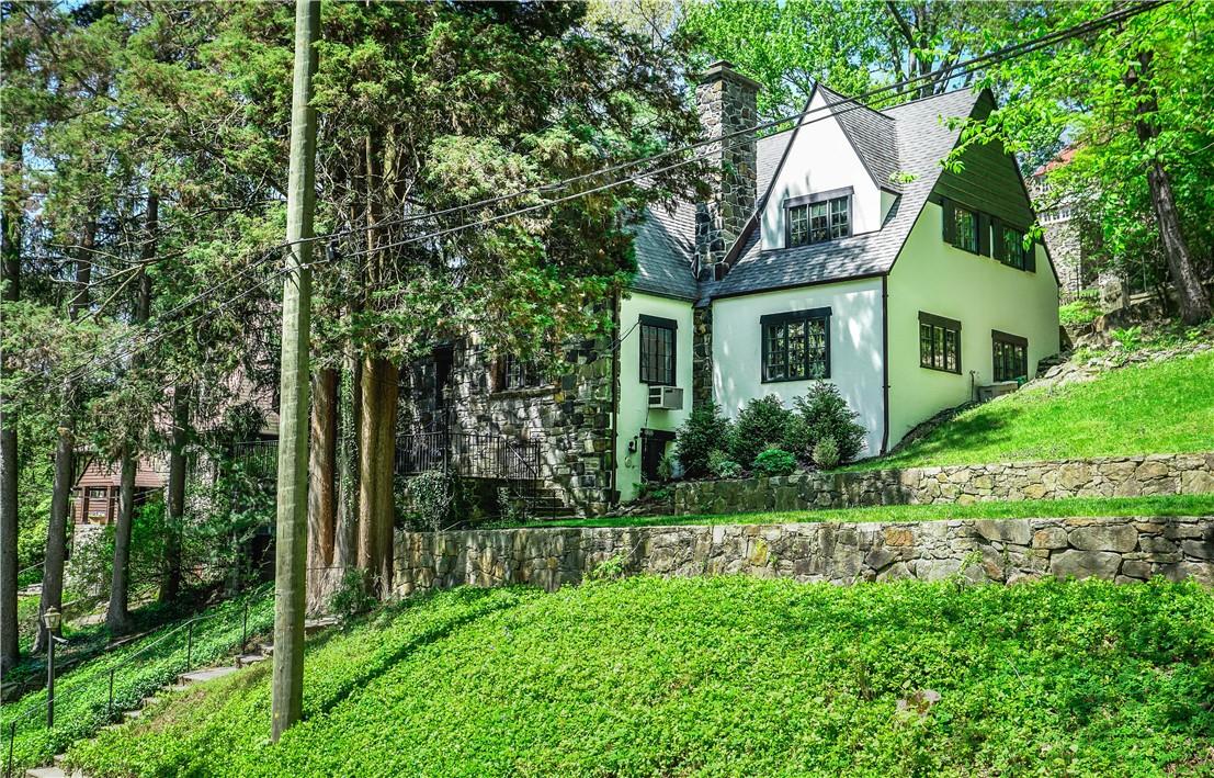 a front view of house with yard and green space