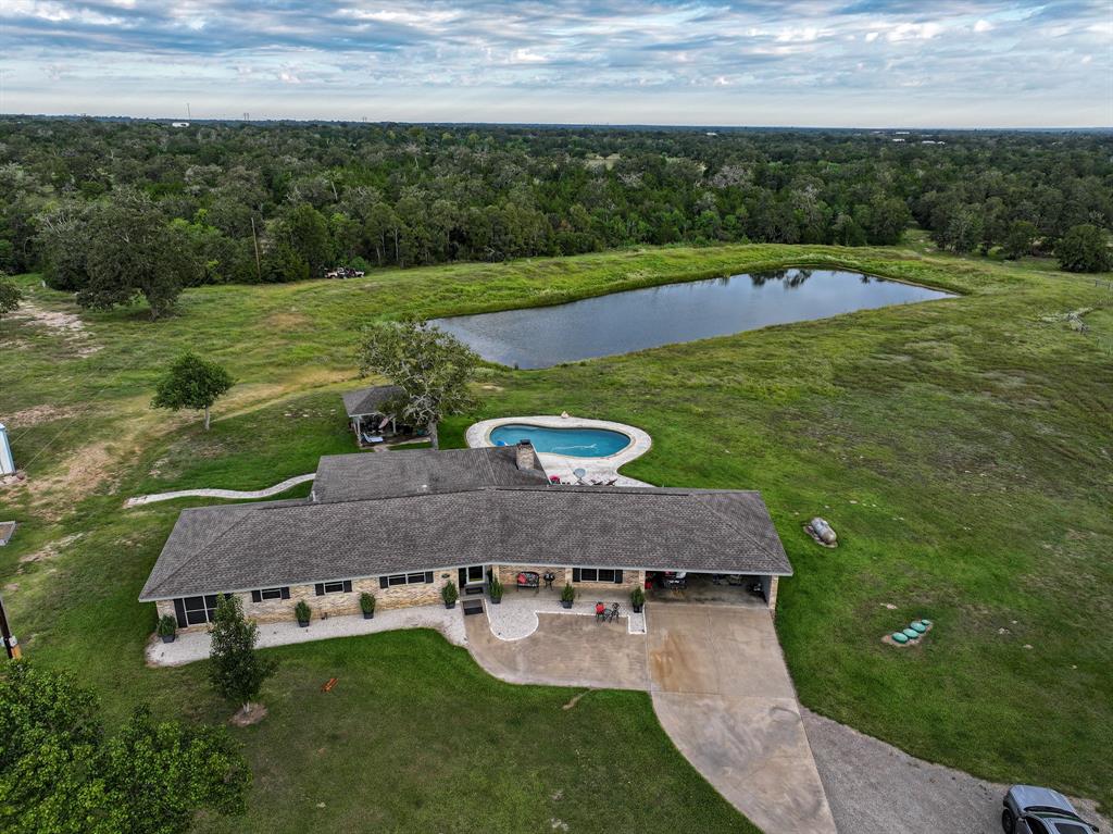 Drone view of home and pond