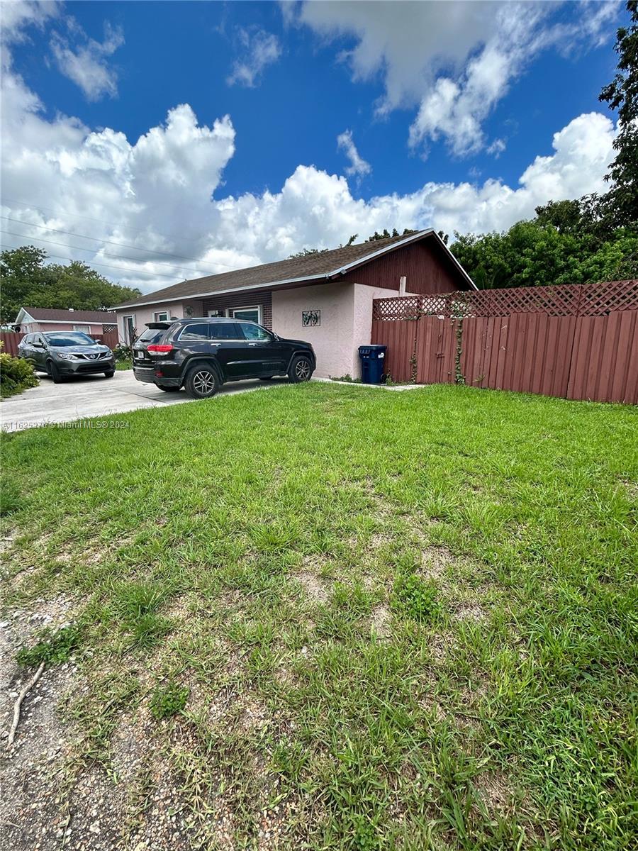 a view of house with backyard space and garden