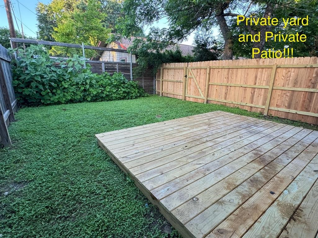 a view of a backyard with a wooden fence